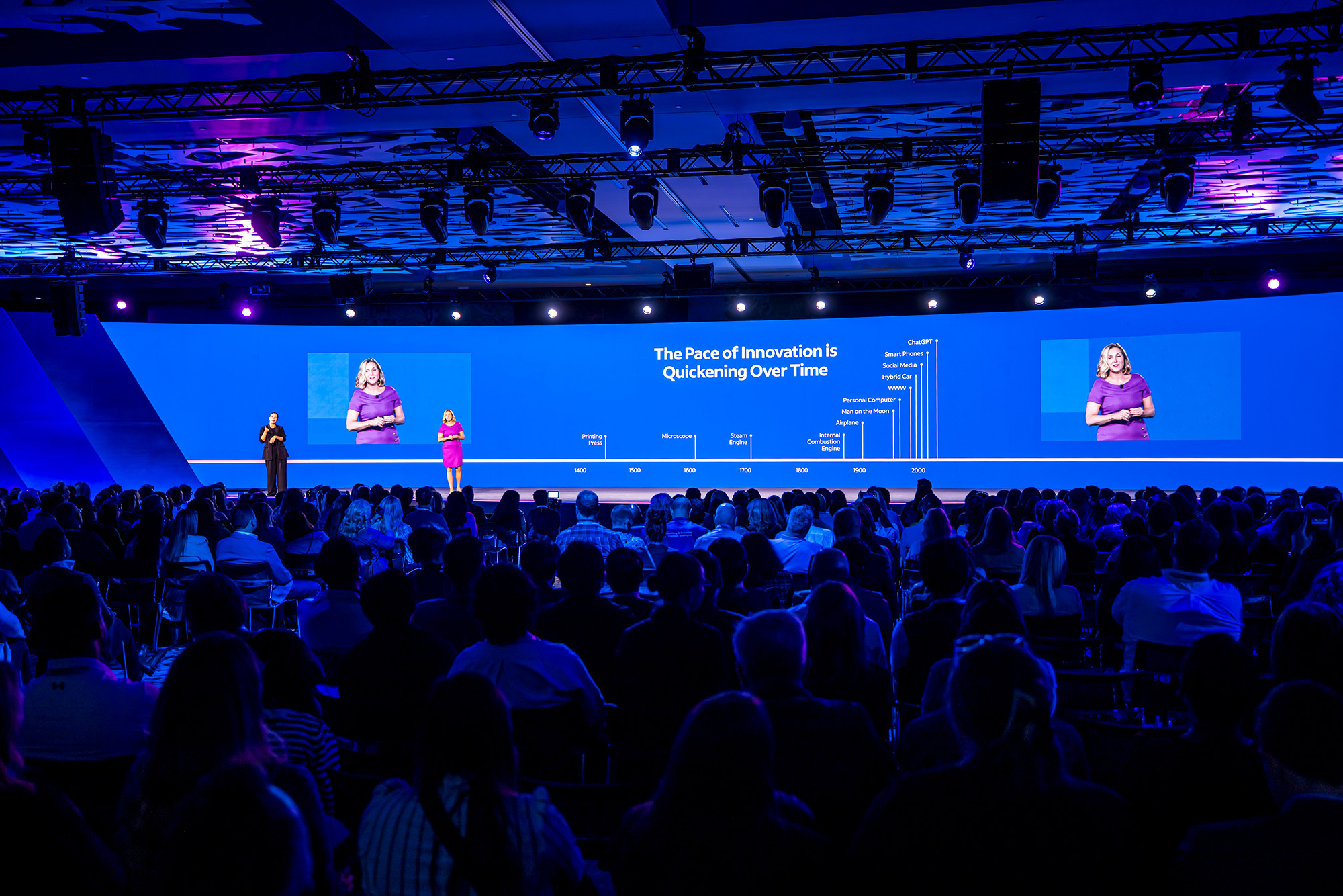 Speaker on stage with large LED backdrop