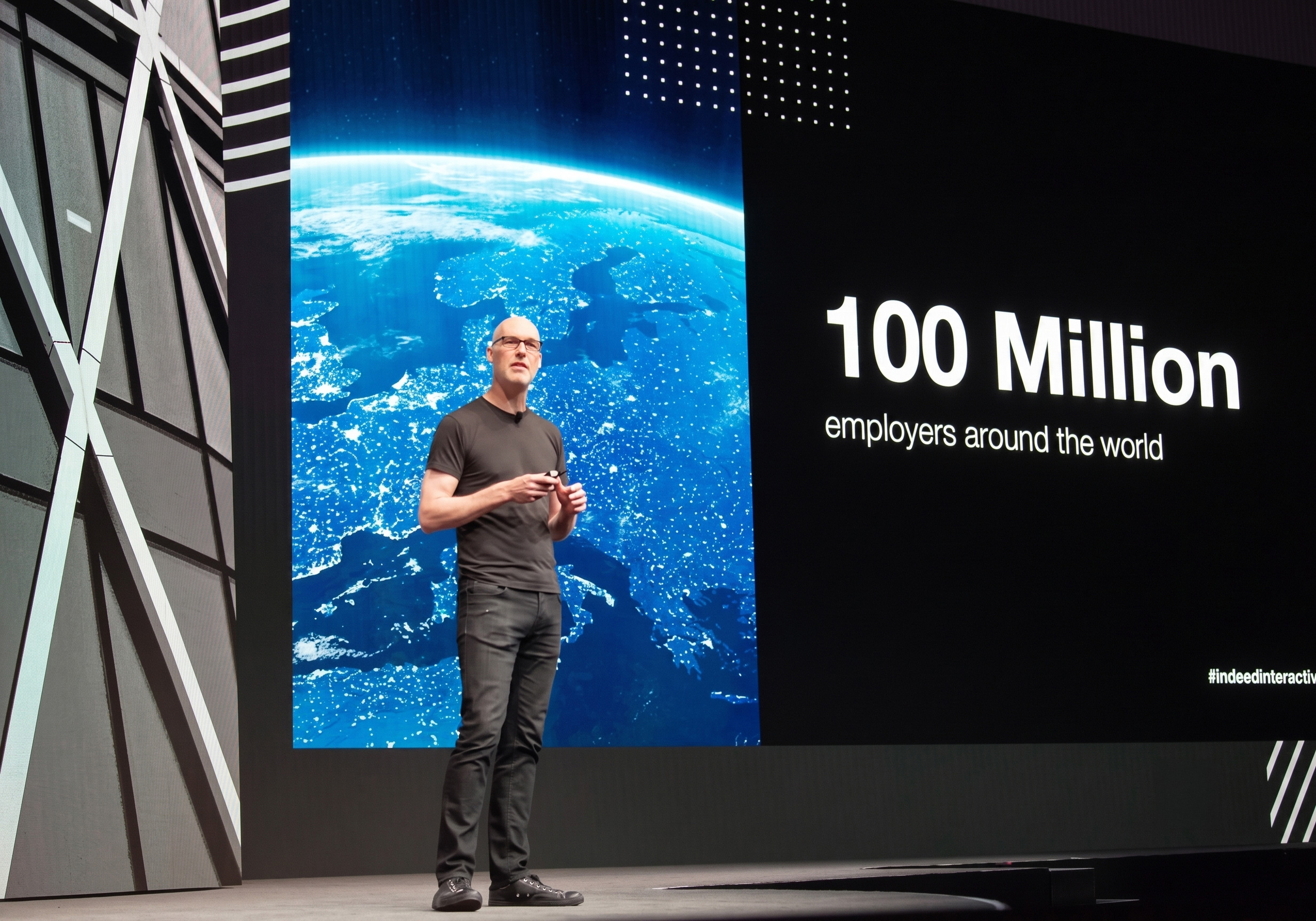 Speaker on stage with slide
